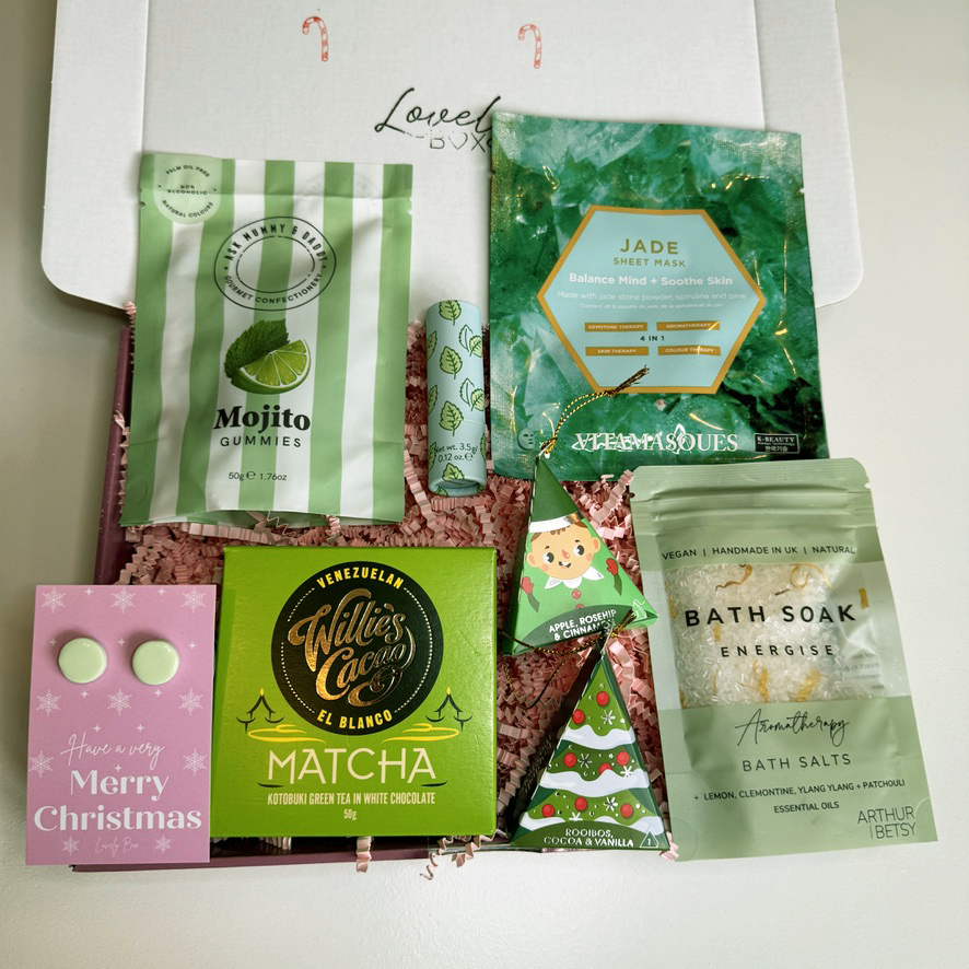 Collection of wellness products including gummies, matcha tea, and bath salts on a white background.