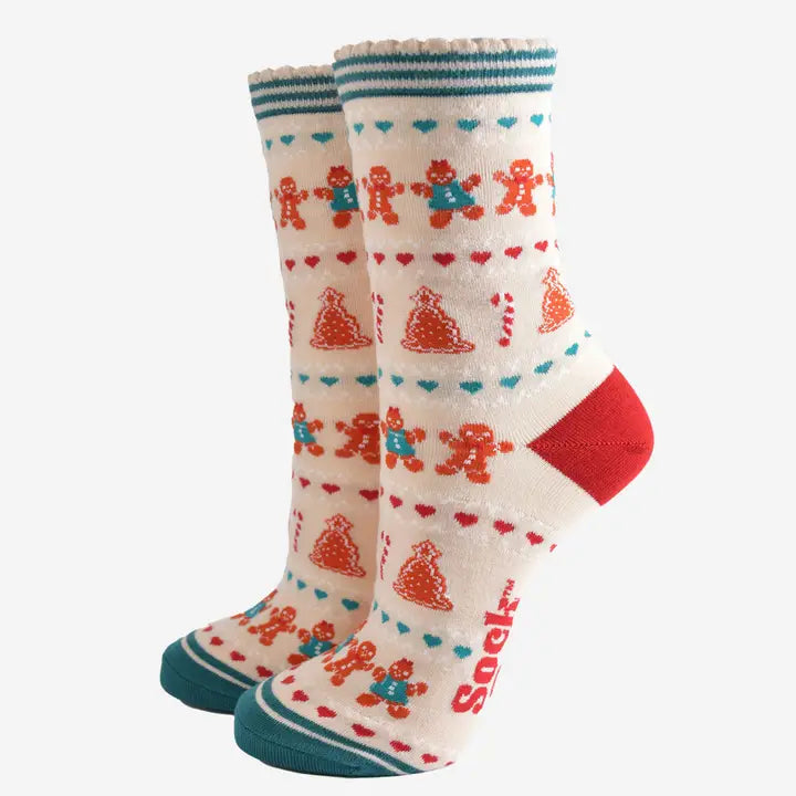 Pair of socks with gingerbread man and heart patterns on a white background