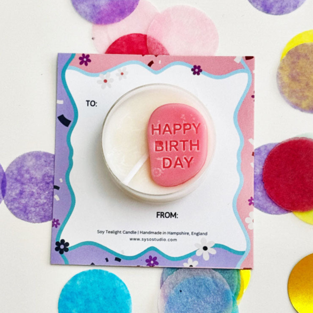 Soy candle with 'Happy Birthday' message on a colorful card surrounded by confetti