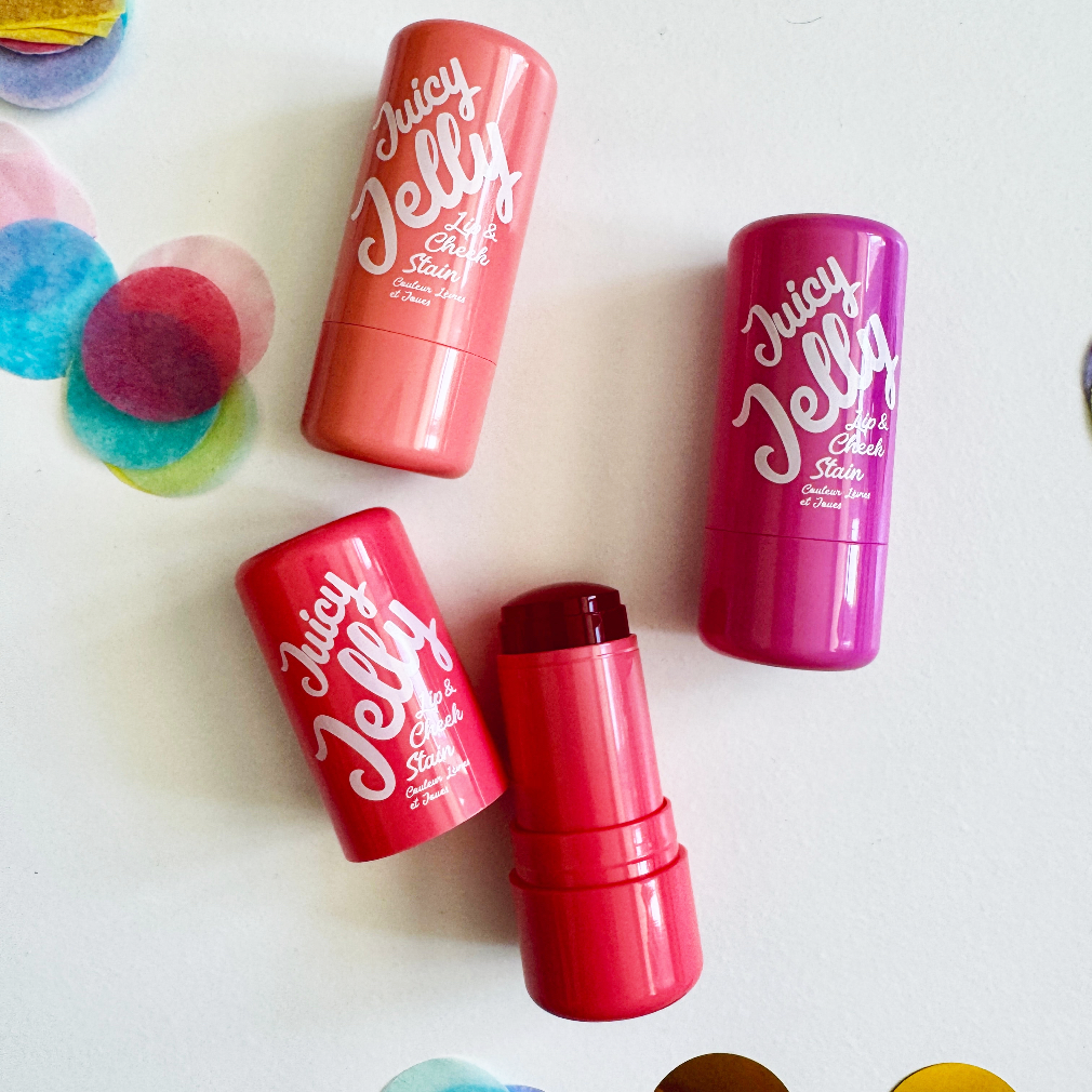 Juicy Jelly lip balm sticks on a white background with colorful jelly beans.