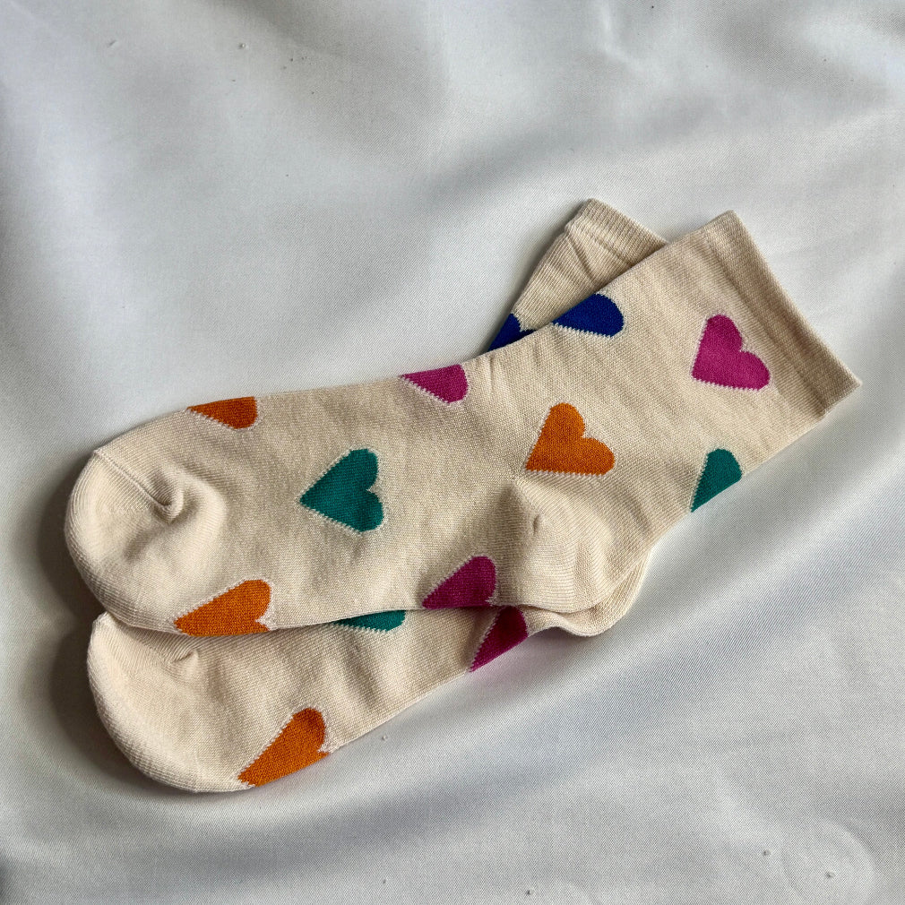 Cream socks with multi coloured heart pattern