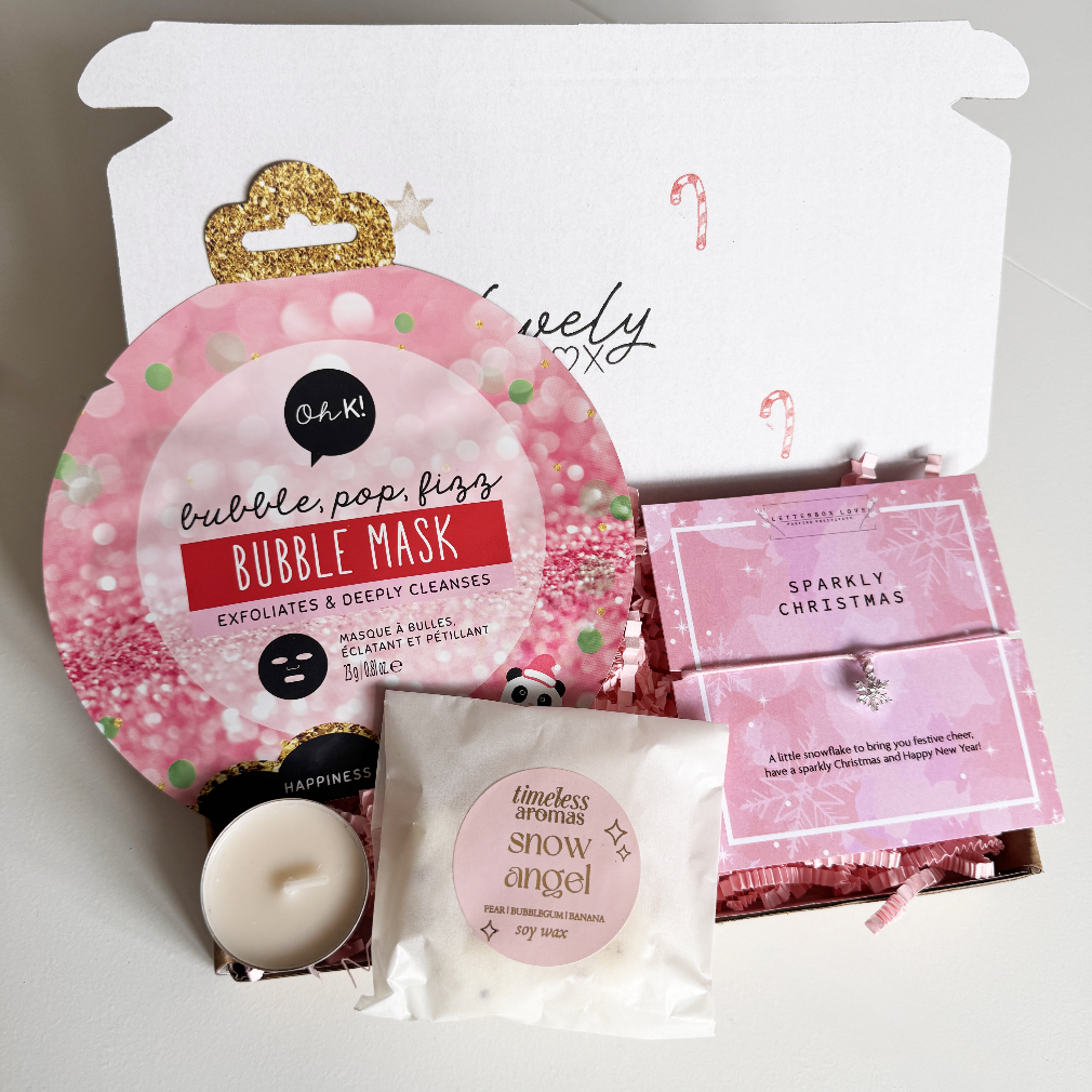 Cosmetic set with bubble mask, candle, and small box on a white background
