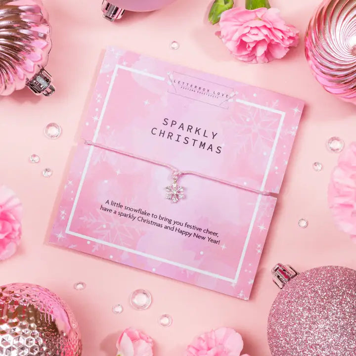 Pink 'Sparkly Christmas' card with decorative elements on a pink background