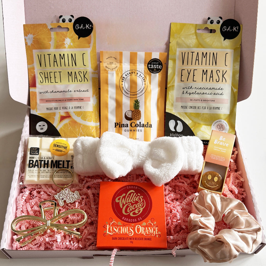 Gifting box with skincare items, gummies, bath melt, and chocolate