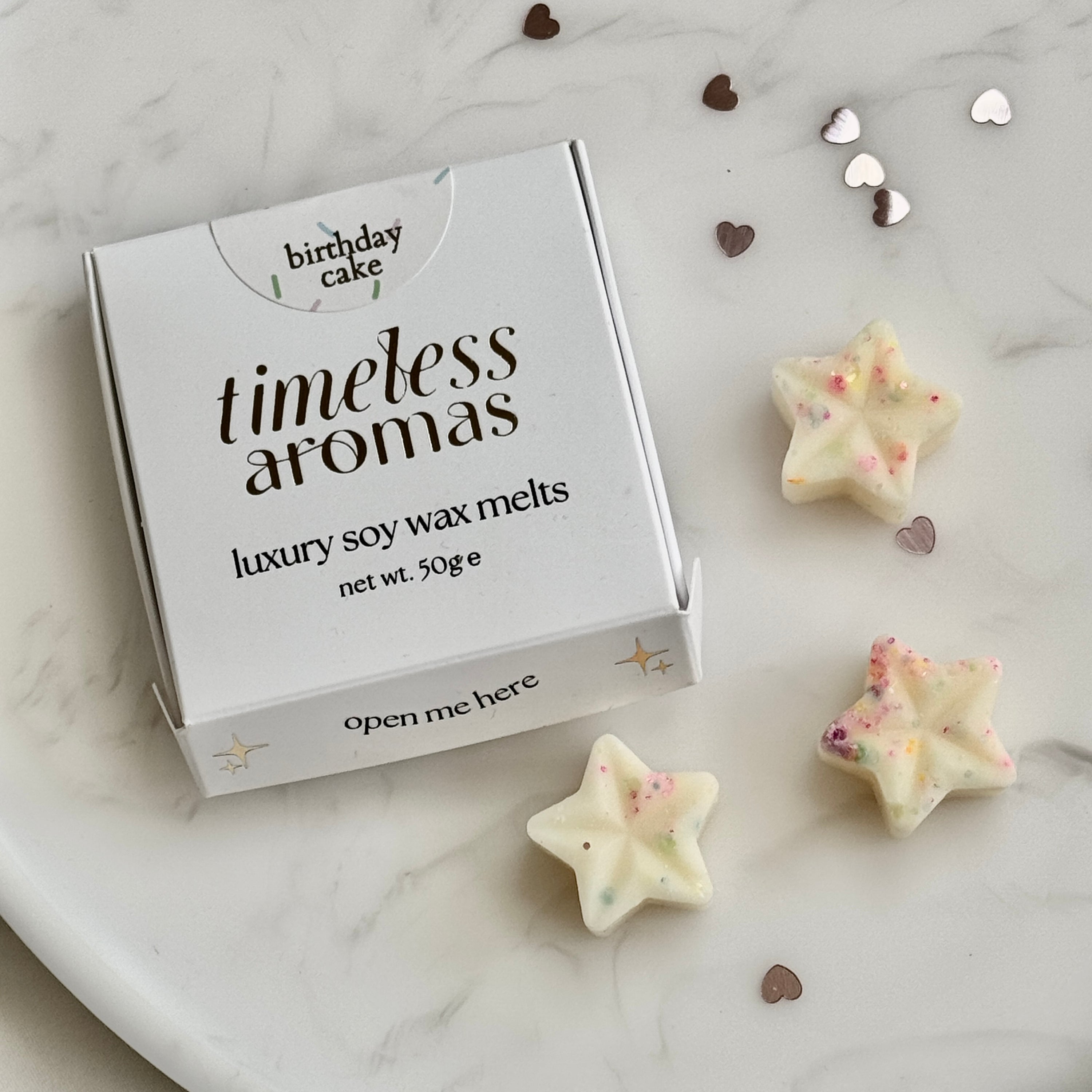 cream star shaped soy wax melts with multicolour glitter. birthday cake scented