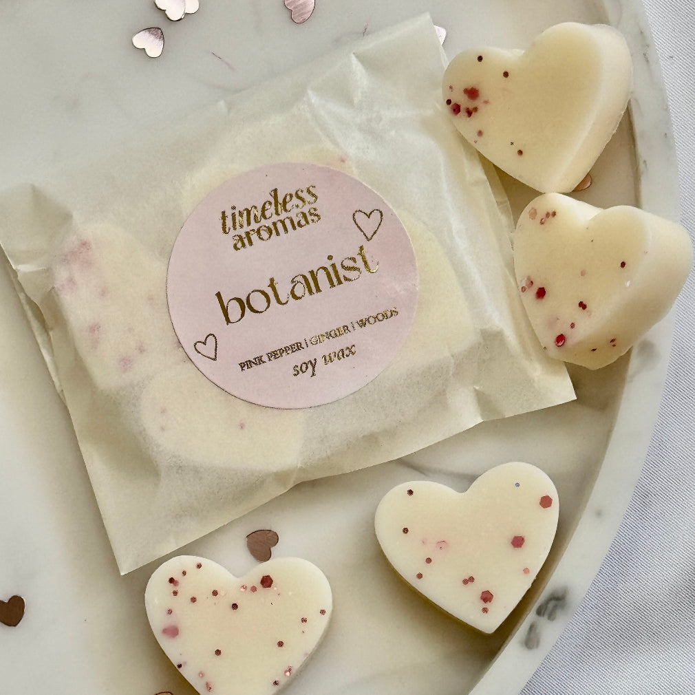 Cream heart shaped soy wax melts with pink glitter. botanist scents