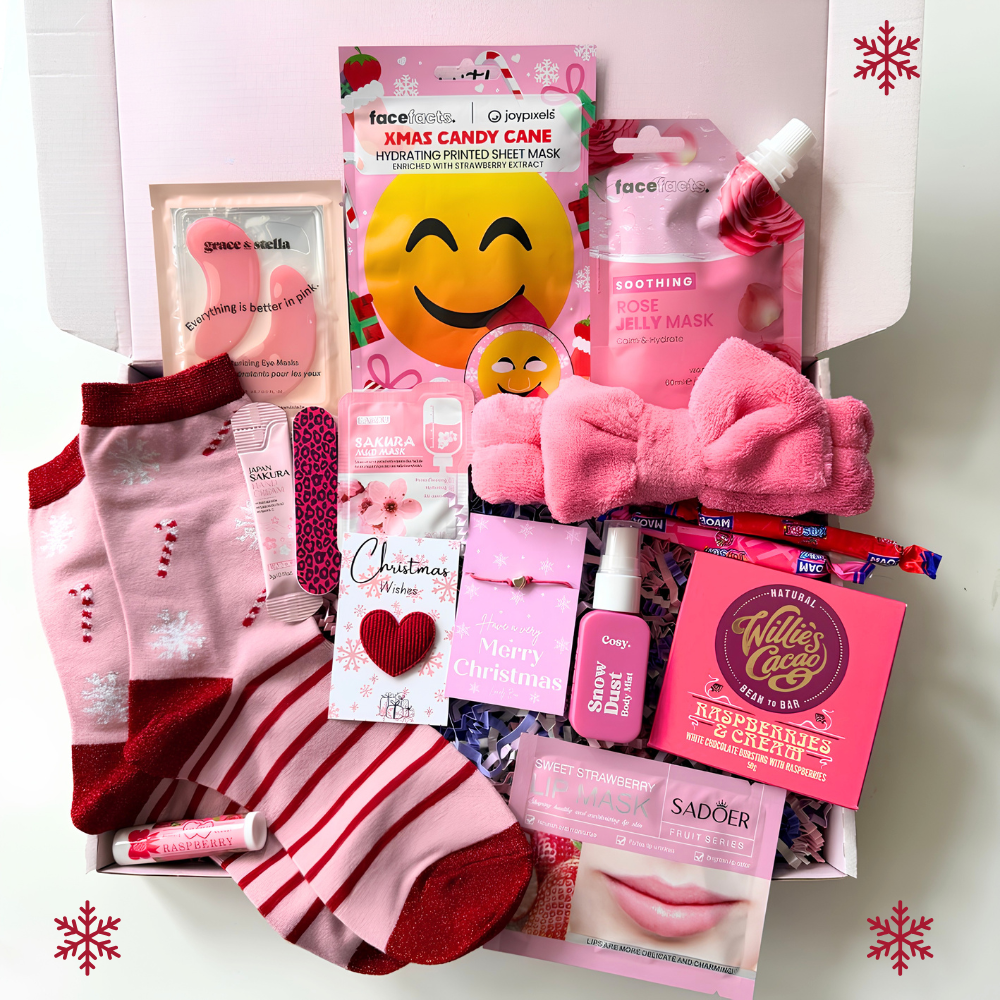 Christmas pamper gift box for her with pink festive socks, skincare face masks, lip balm, spa headband, chocolate and self-care treats.