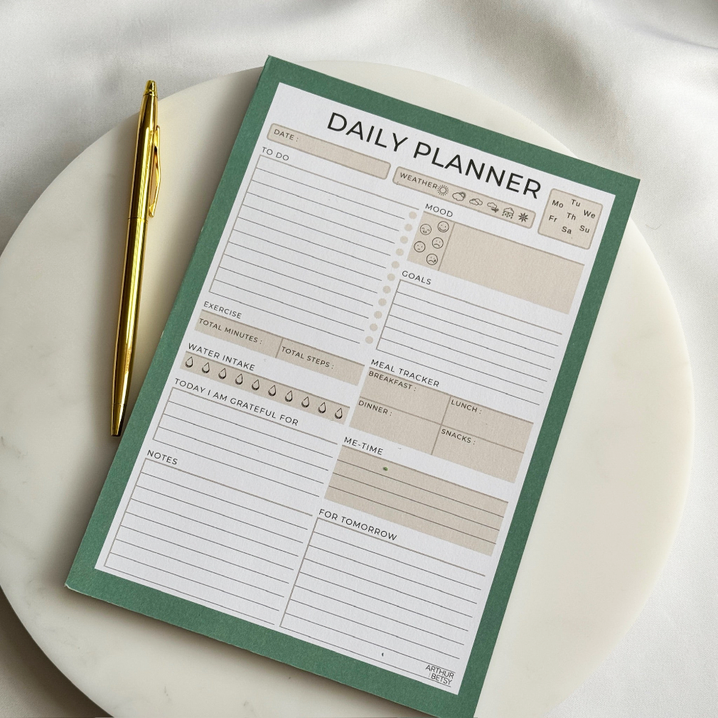 Daily planner with a pen on a white surface