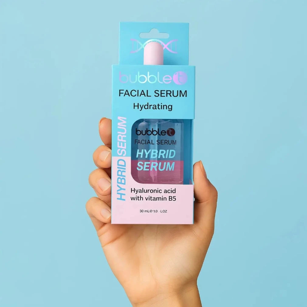 Hand holding a box of bubble T Facial Serum Hybrid Serum against a light blue background