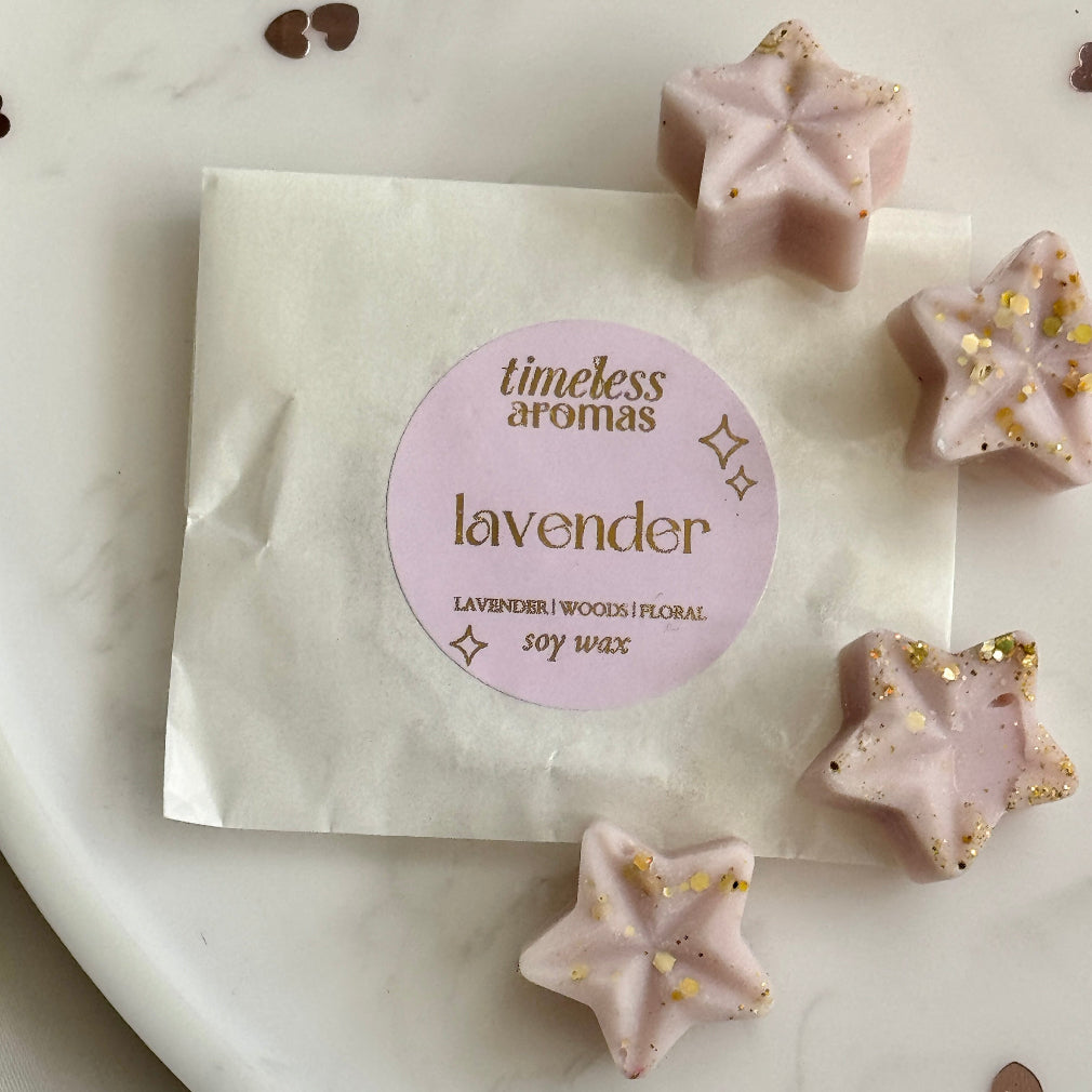 Purple star shaped soy wax melts with gold glitter. Lavender scented