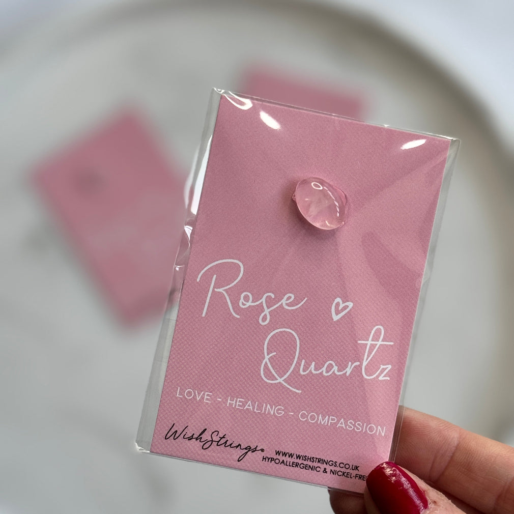 rose quartz crystal on a backing card