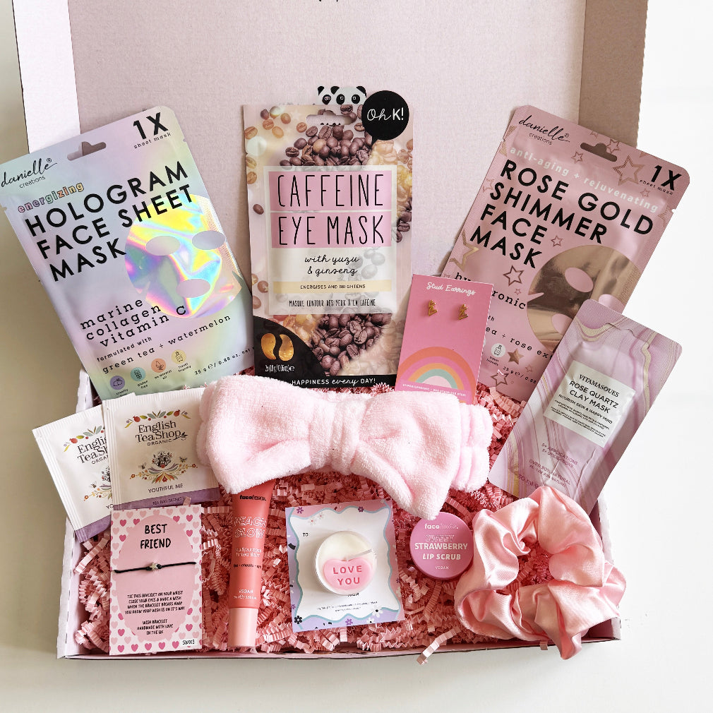 Collection of skincare products and accessories including face masks and a hair bow on a white surface.