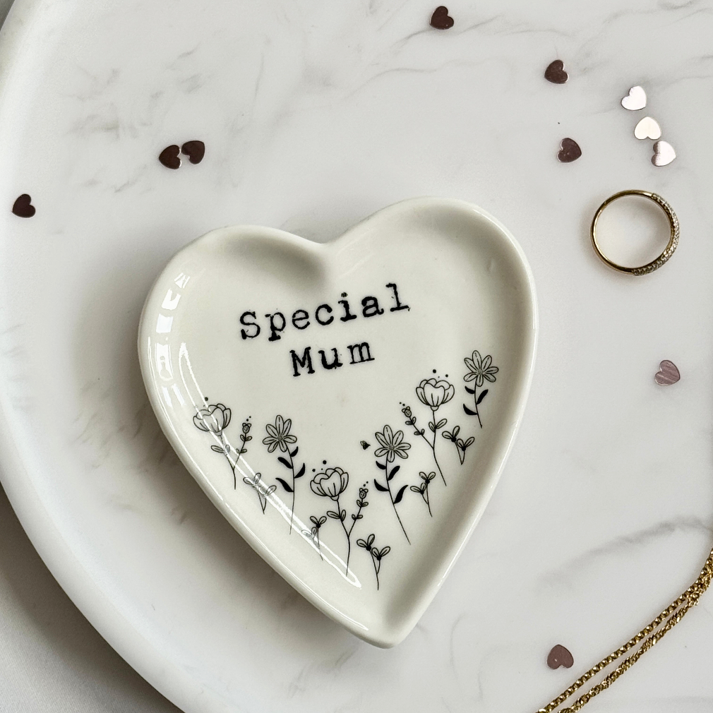 Heart-shaped ceramic dish with 'Special Mum' text on a marble surface.