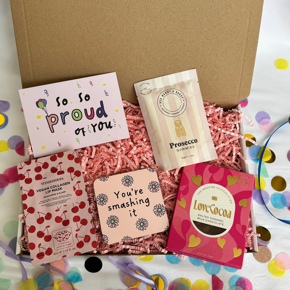 A gift box with edible gifts, skincare and a You're smashing it coaster. Also a proud of you themed card