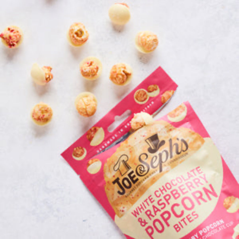 Joe & Sephs white chocolate raspberry popcorn bites on a light gray background