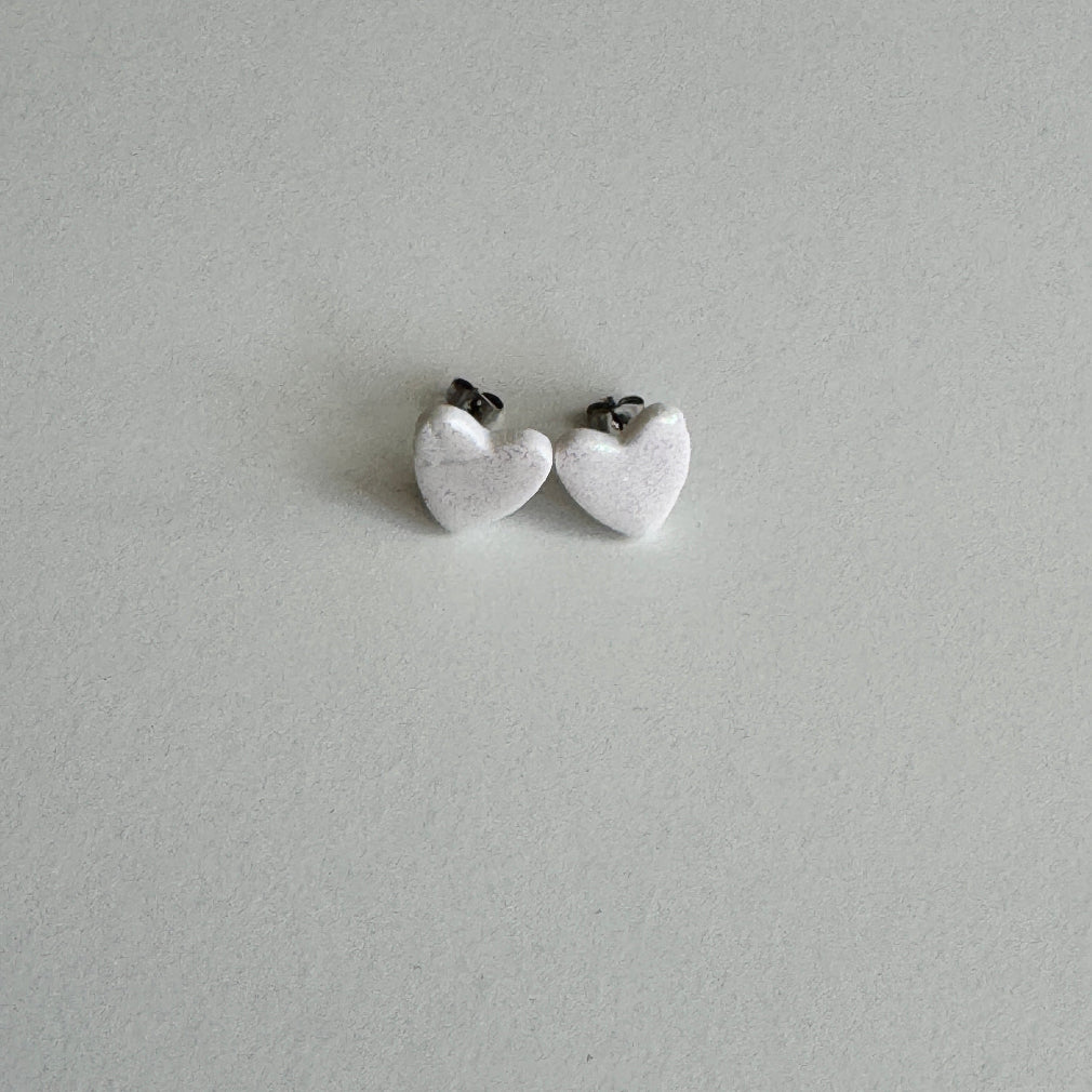 white glitter heart shaped polmer clay earrings with stainless steel post and butterfly backs