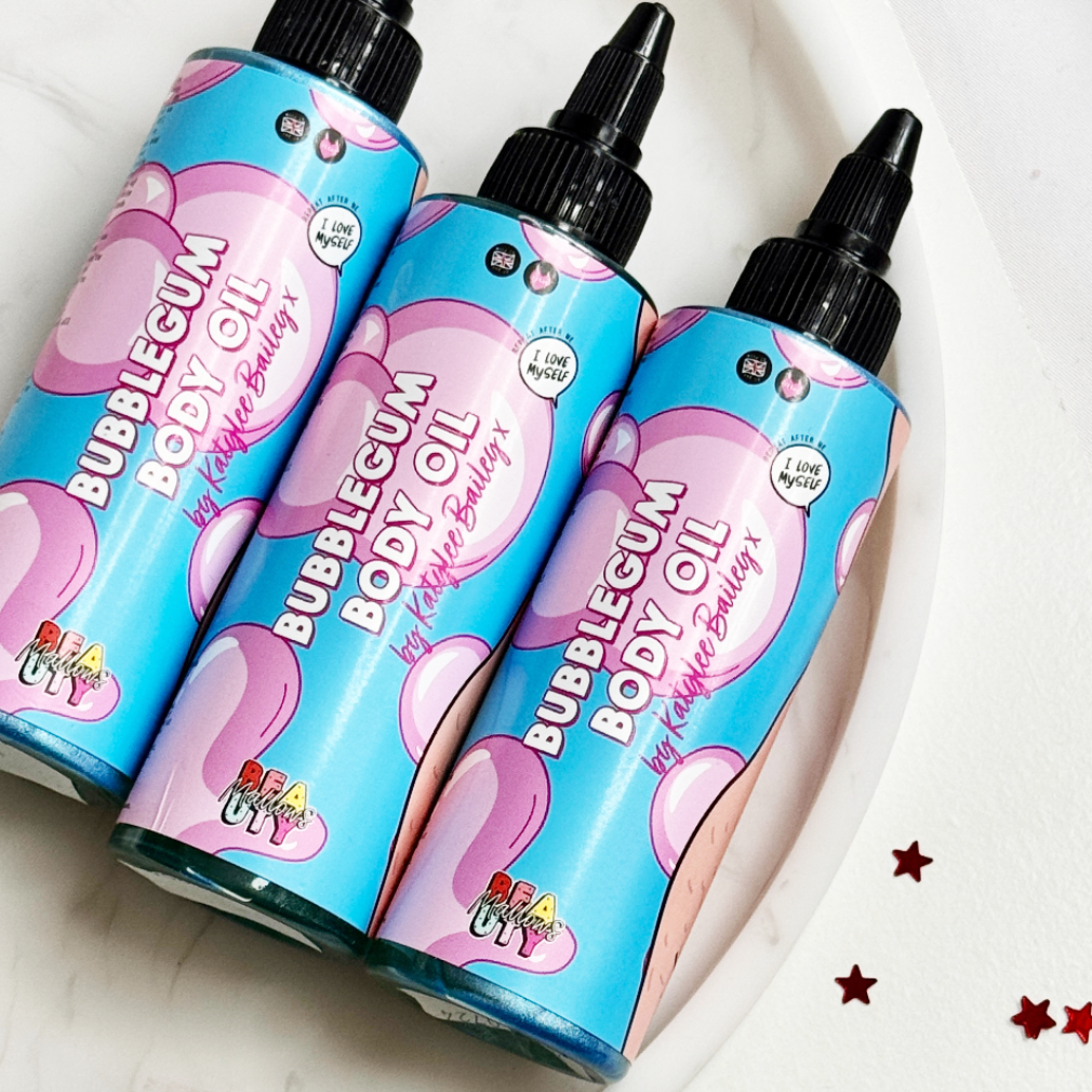 Three bottles of bubblegum body oil on a white background