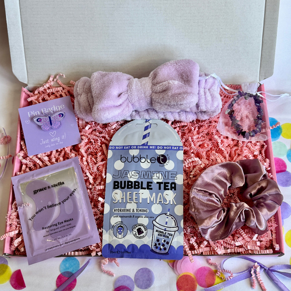 treatbox including skincare, edible treats and keepsakes with a themed note card all lilac themed