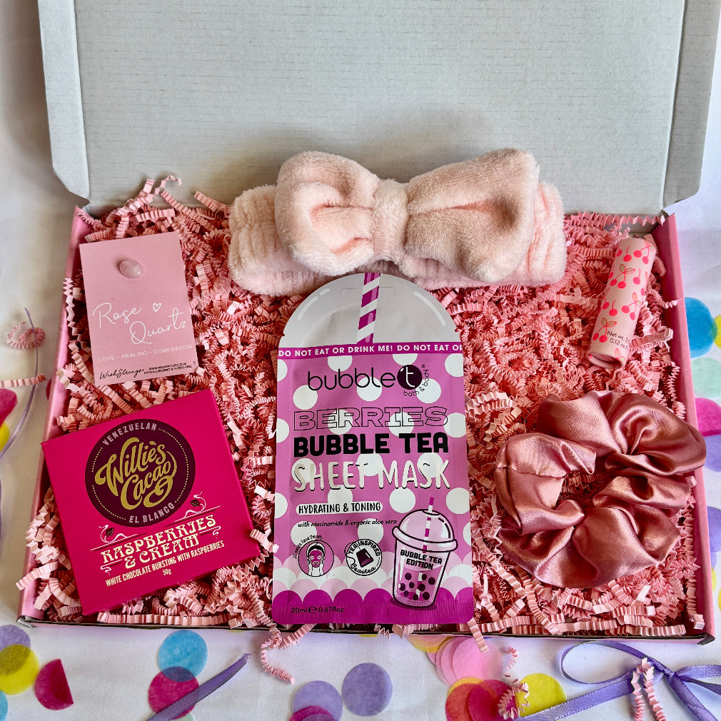 treatbox including skincare, edible treats and keepsakes with a themed note card pink themed